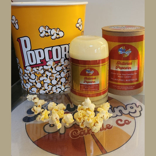 Popcorn bucket, popcorn container, and popcorn on a branded surface, candle