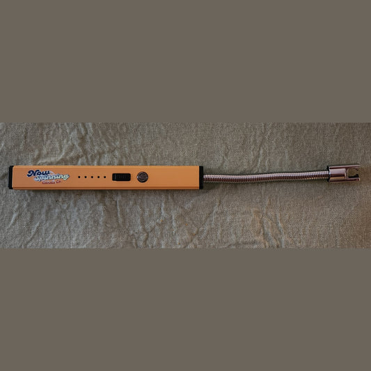 Orange electronic device with a coiled cable on a textured gray surface