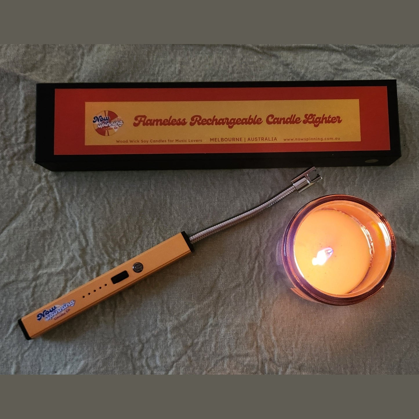 Flameless rechargeable candle lighter with packaging on a textured surface