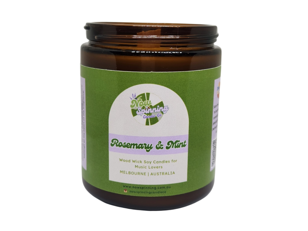 Jar of candle with green label on a white background