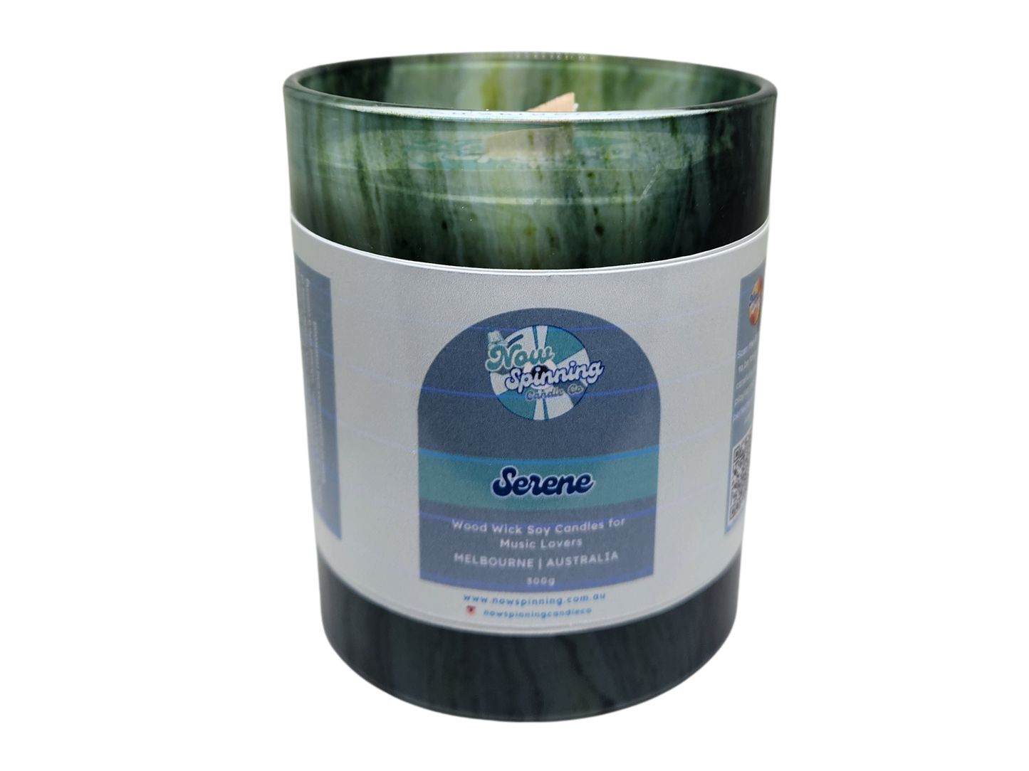 Candle in a green and black container with a label on a white background