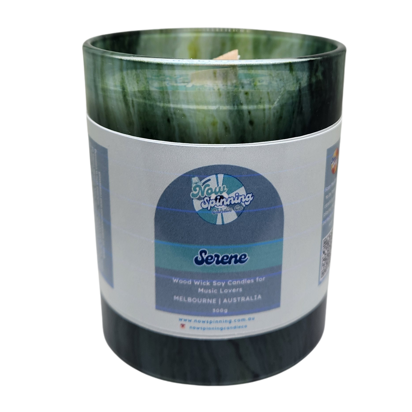 Candle in a green and black container with a label on a white background