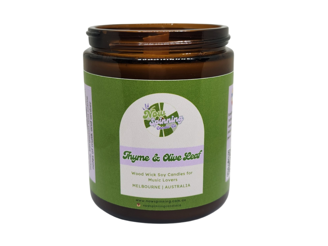 Brown candle jar with green label on a white background