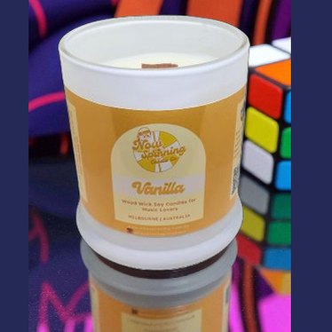 Vanilla scented candle in a white container with a colorful background
