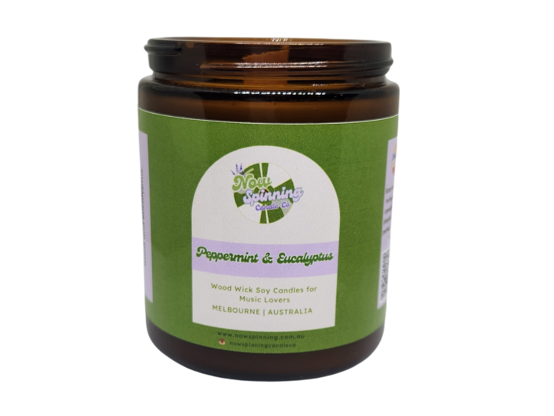 Candle jar with green label on a white background