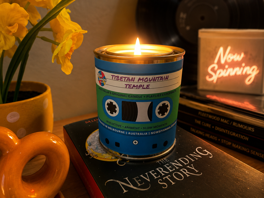 Now Spinning Tibetan Mountain Temple candle with a curated playlist, styled with vinyl records and retro decor.
