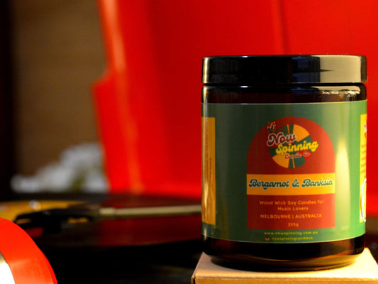 Bergamot and Banksia candle with a label on a red background