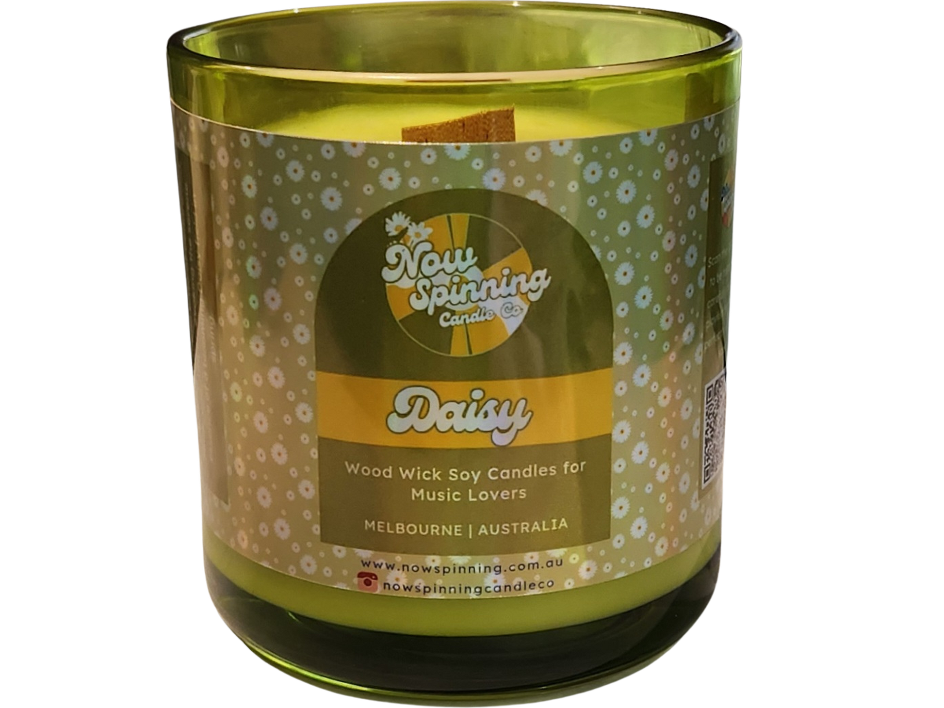 Green candle with a decorative label on a white background