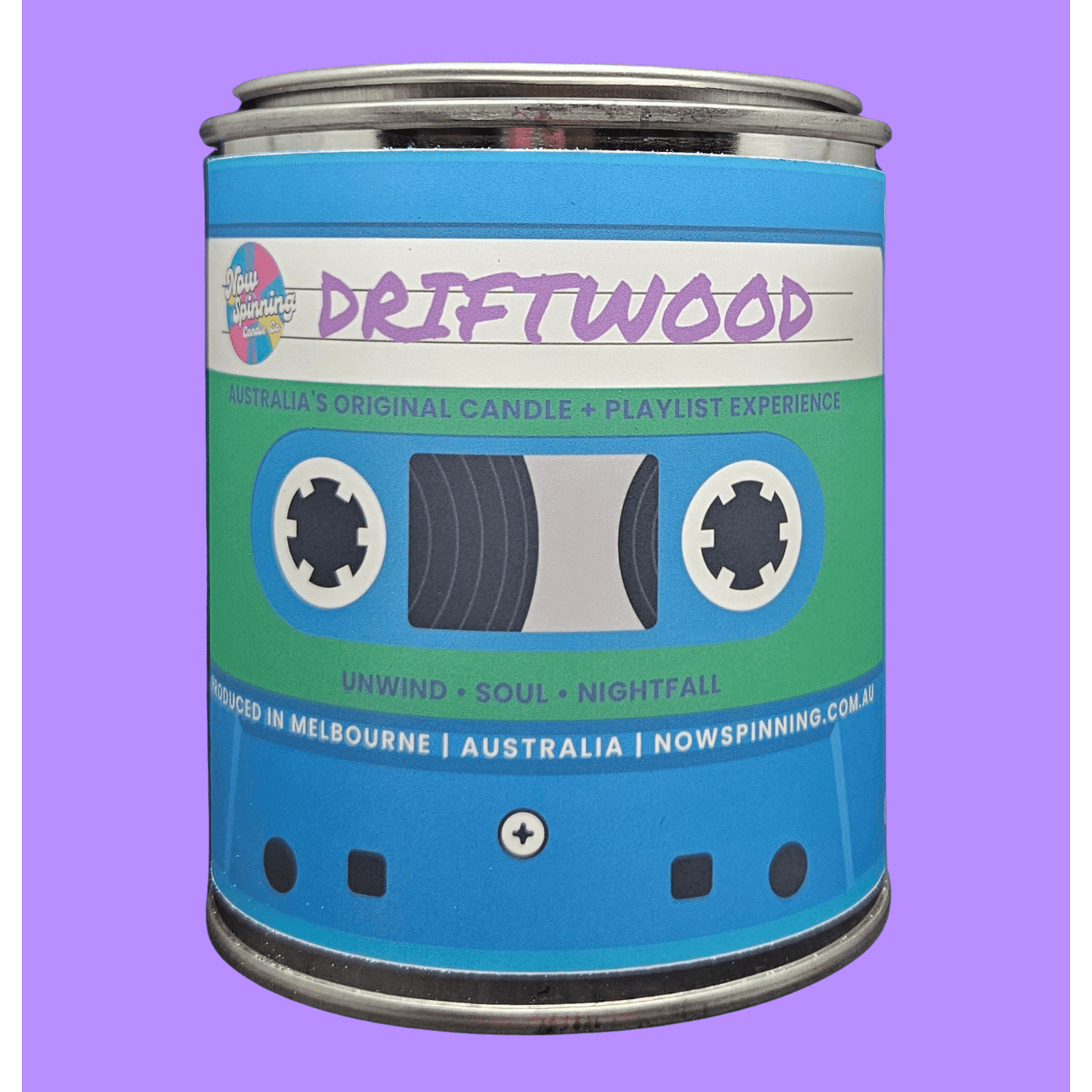 A cylindrical metal tin styled like a retro cassette tape, labeled 'DRIFTWOOD' by Nowspinning, set against a solid lavender background.