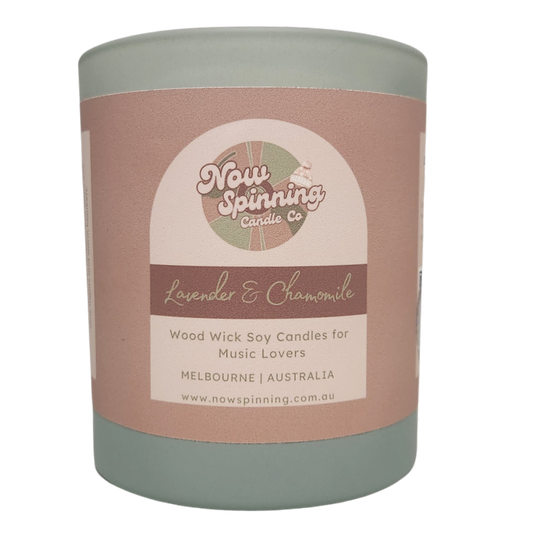 Lavender & Chamomile scented soy candle with a crackling wood wick, styled beside a relaxing bubble bath. Hand-poured in Melbourne and paired with a curated playlist for the ultimate self-care experience.