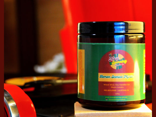 Lemon Scented Myrtle Candle with a colorful label on a wooden surface.
