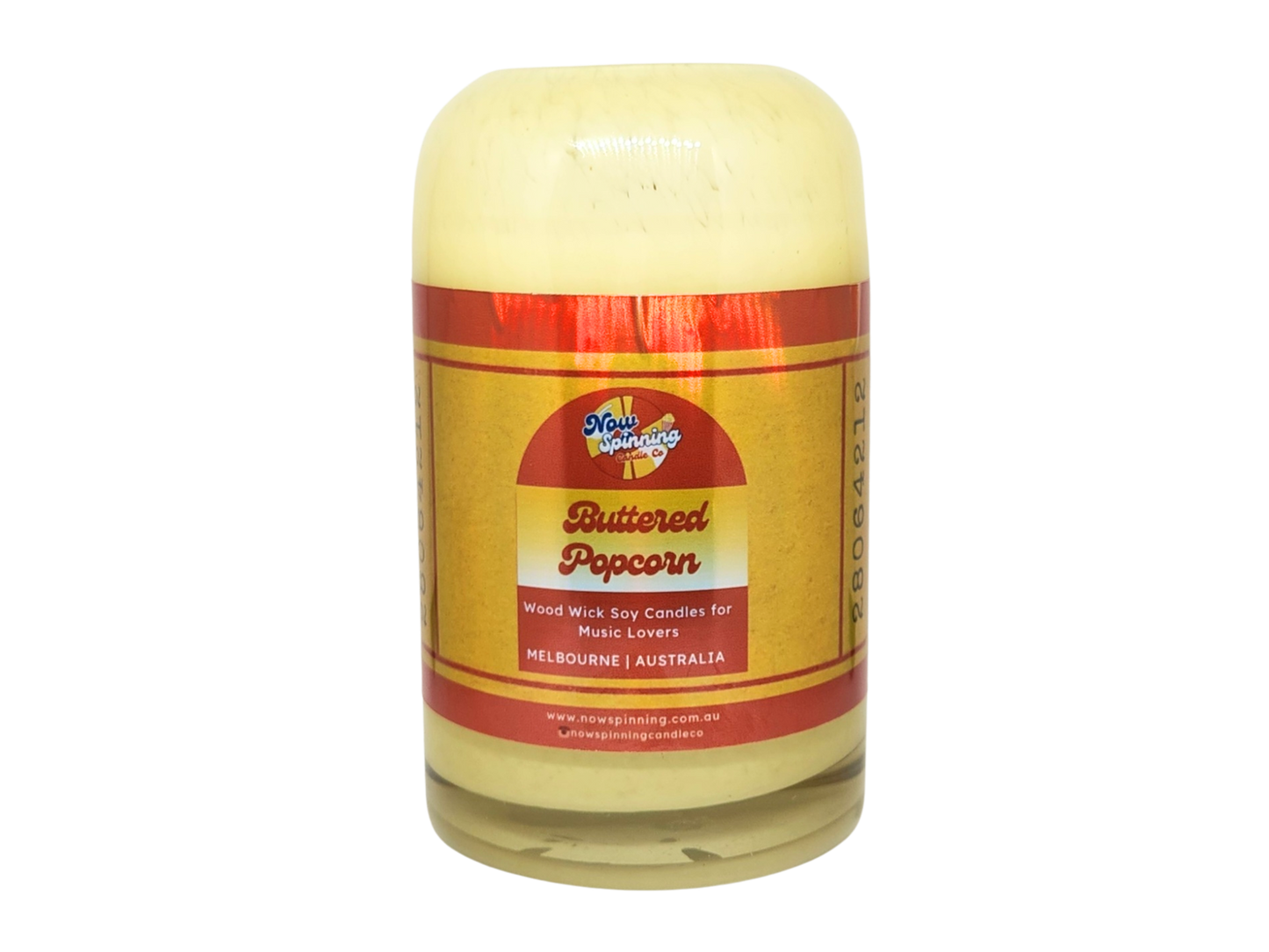 Buttered Popcorn candle in a glass jar with a red label on a white background