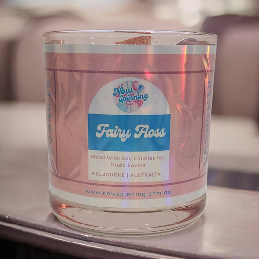 Candle in a glass jar with a label on a blurred background