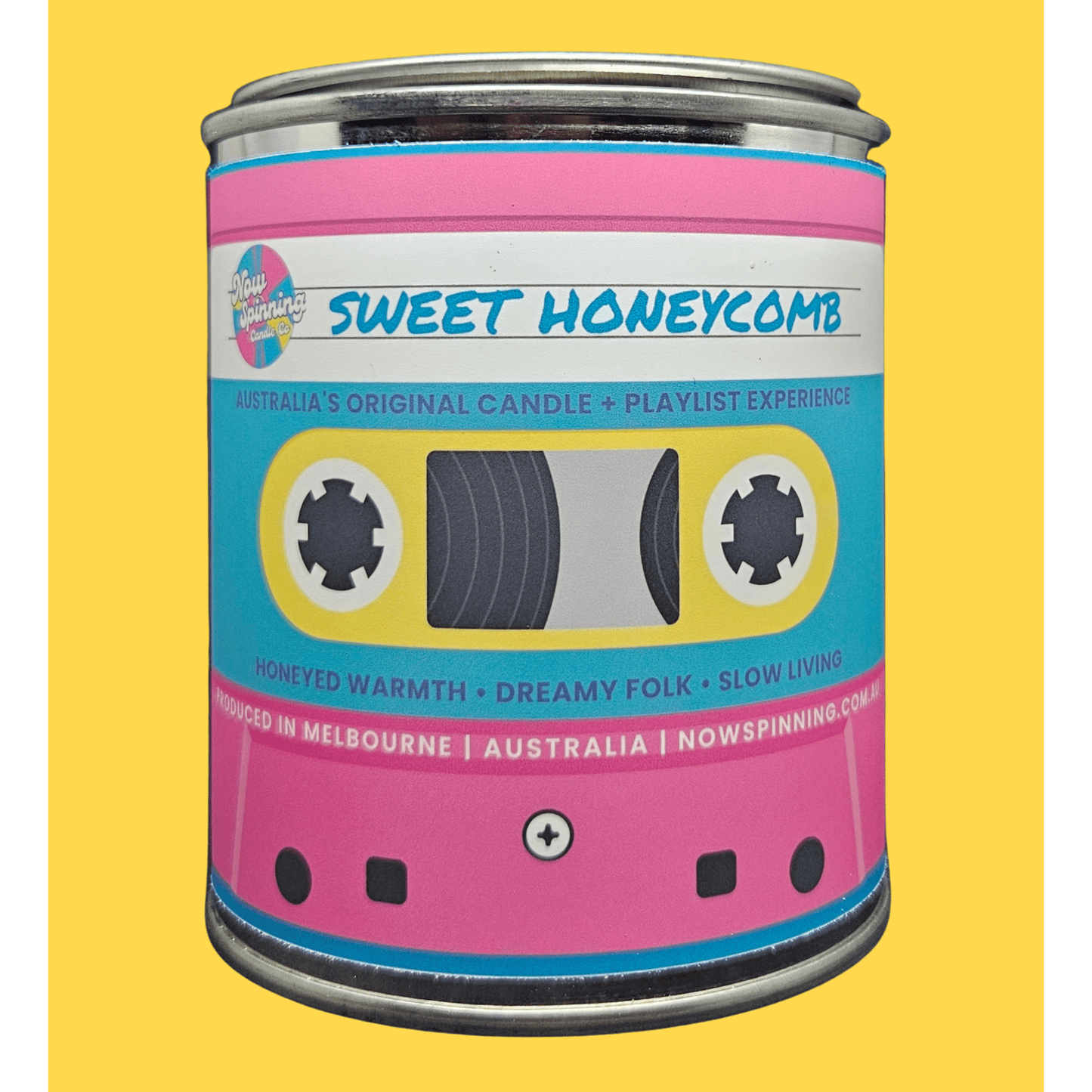 A novelty tin candle designed to look like a retro cassette tape, featuring a pink and cyan label with the text 'SWEET HONEYCOMB' and 'Australia's Original Candle + Playlist Experience'.