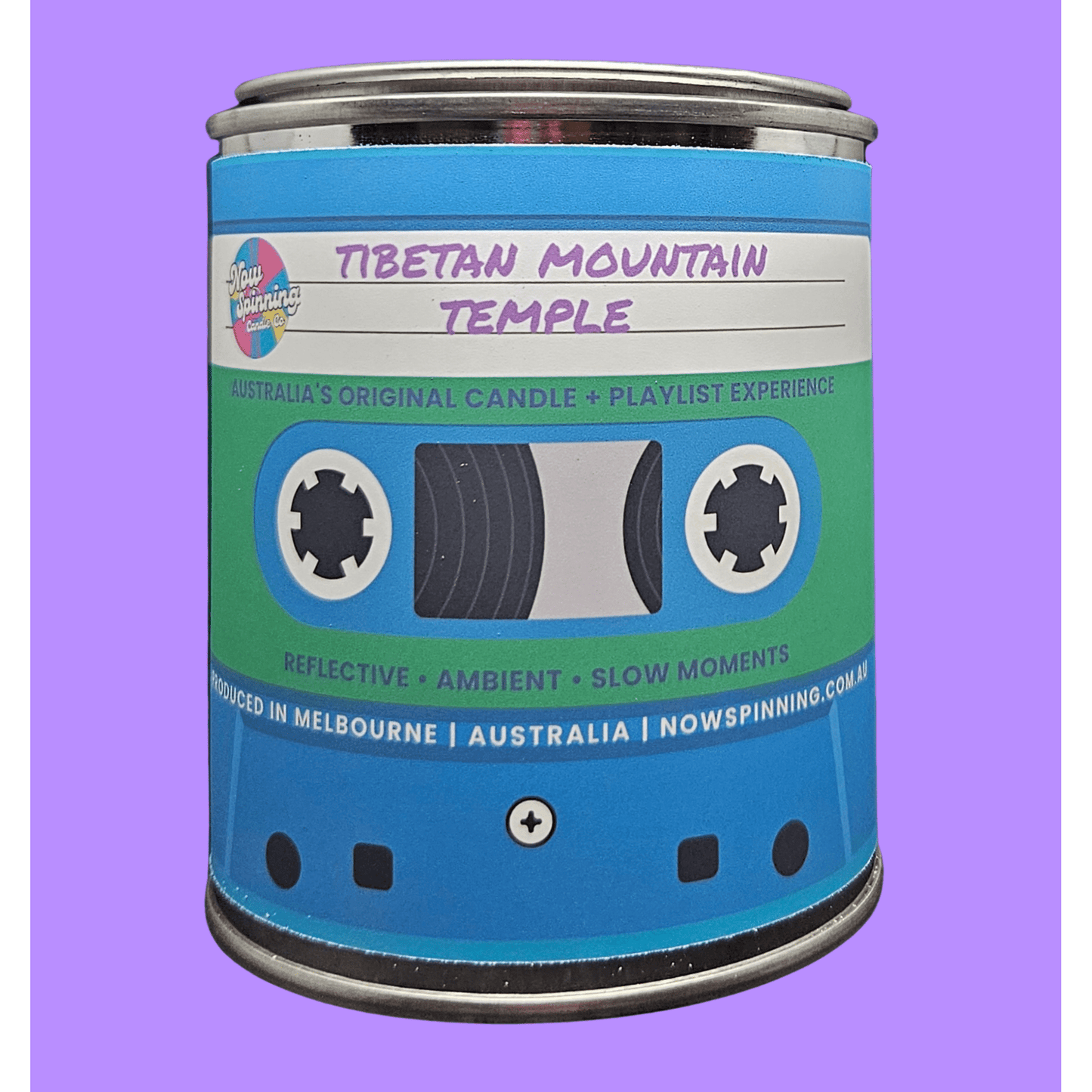 A cylindrical metal candle tin styled like a retro cassette tape, labeled 'Tibetan Mountain Temple' on a solid purple background.