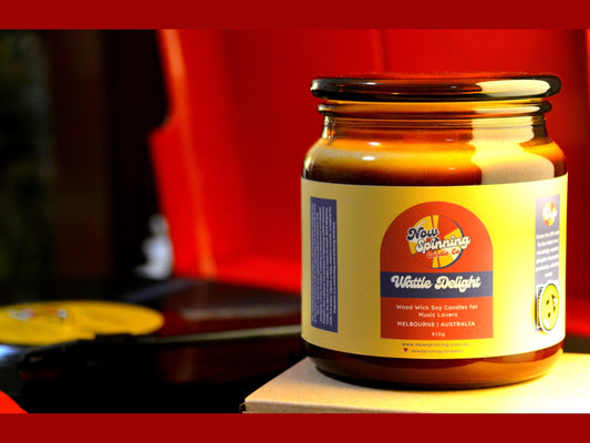 Jar of 'Wattle Delight' on a wooden surface with a red record player